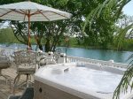 Outdoor Hot tub patio table, umbrella and chairs up river view